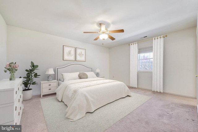 bedroom featuring visible vents, ceiling fan, light carpet, and baseboards