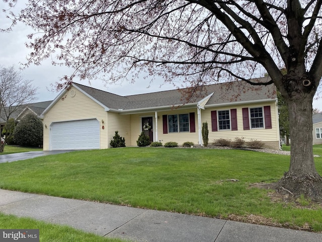 single story home with aphalt driveway, an attached garage, and a front yard