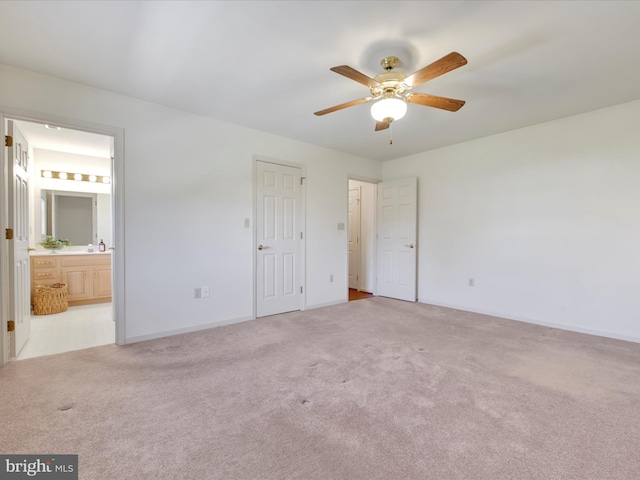 unfurnished bedroom featuring ceiling fan, ensuite bath, baseboards, and carpet floors