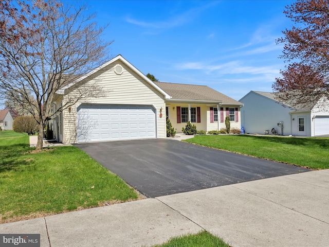 single story home featuring a front yard, driveway, and an attached garage