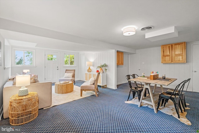 dining space featuring baseboards, visible vents, and dark colored carpet