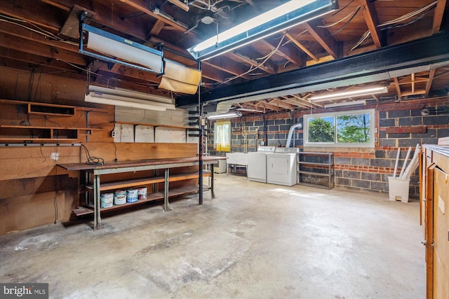 below grade area with washer and clothes dryer, a sink, and a workshop area