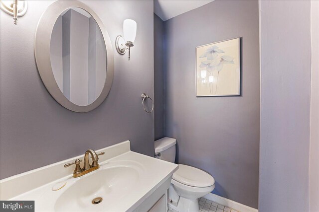 bathroom featuring vanity, baseboards, and toilet