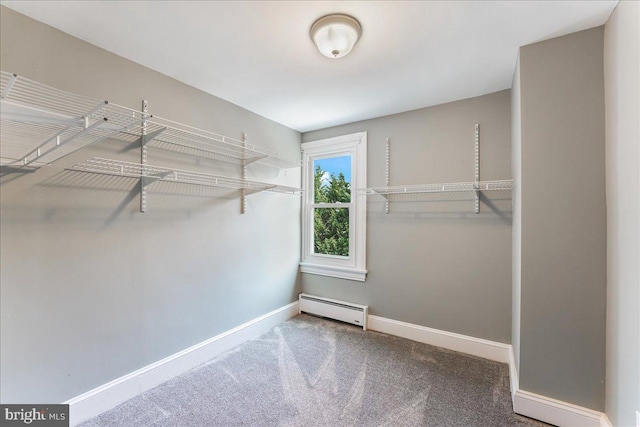 spacious closet featuring a baseboard radiator and carpet floors