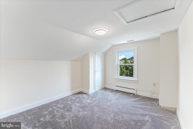 additional living space with baseboard heating, attic access, vaulted ceiling, and carpet floors