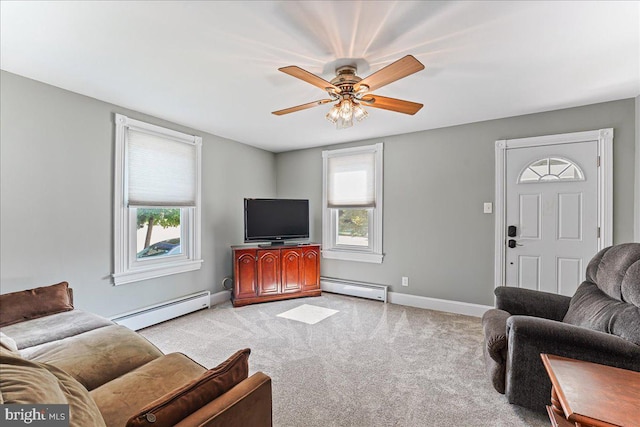 carpeted living area featuring baseboard heating, baseboards, and a ceiling fan