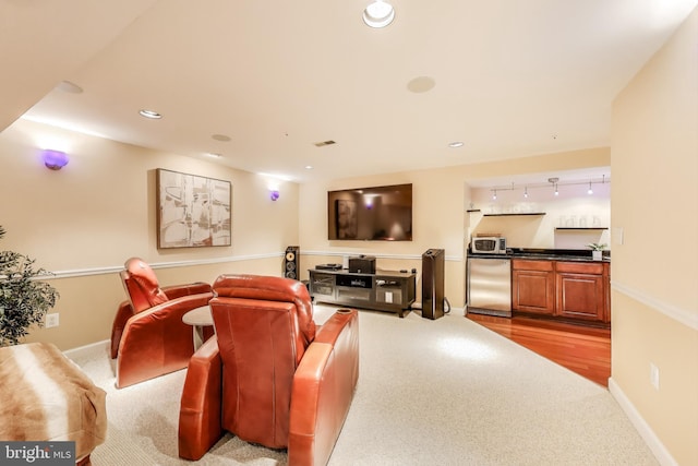 10107 Linford Ter, Lanham, MD 20706 - carpeted home theater room with bar, baseboards, and rail lighting
