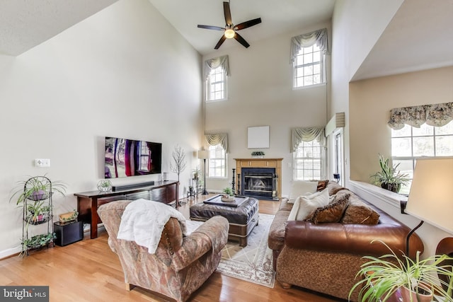 10107 Linford Ter, Lanham, MD 20706 - living room with a ceiling fan, wood finished floors, high vaulted ceiling, and a glass covered fireplace