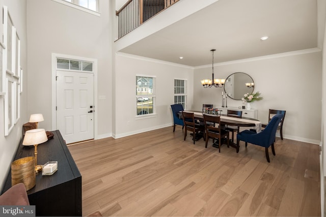 foyer with baseboards, a notable chandelier, and a wealth of natural light