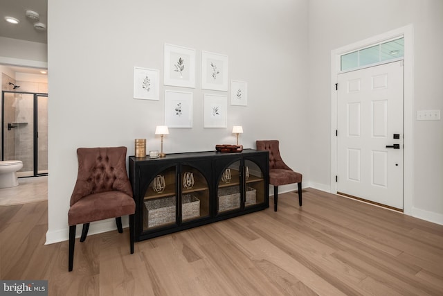 entryway with baseboards and wood finished floors