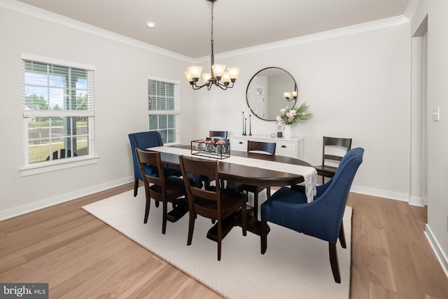 dining area featuring baseboards, ornamental molding, wood finished floors, and a chandelier