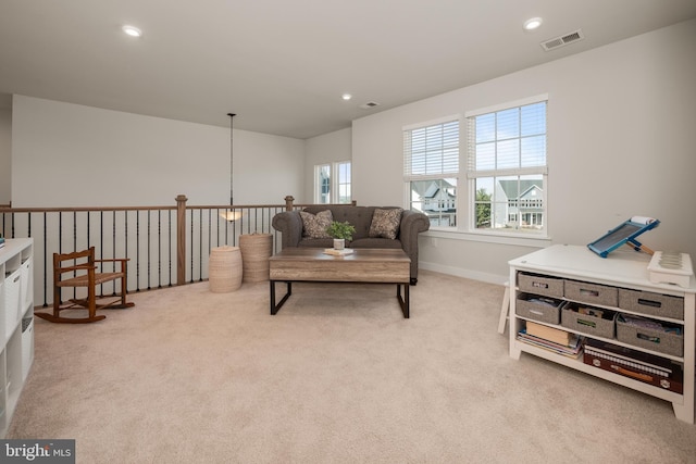 carpeted living room featuring baseboards, a notable chandelier, recessed lighting, and visible vents