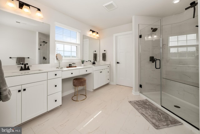 full bathroom with a sink, a marble finish shower, marble finish floor, baseboards, and two vanities