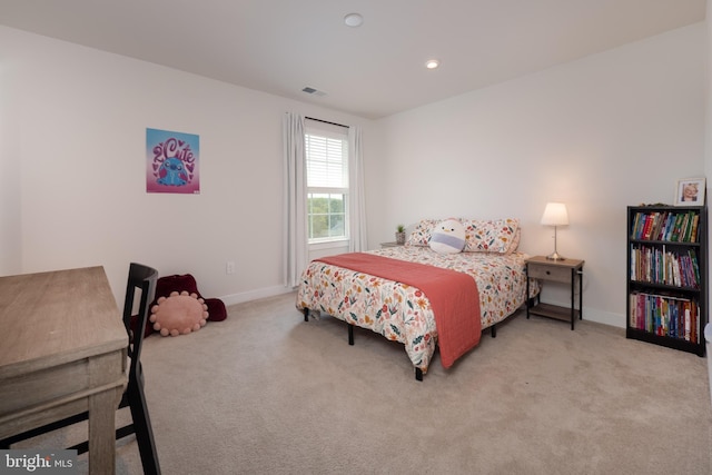 bedroom with baseboards, visible vents, and carpet