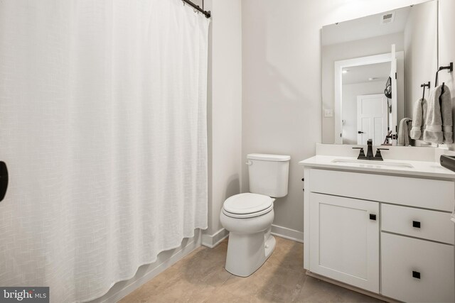 bathroom featuring toilet, baseboards, visible vents, and vanity