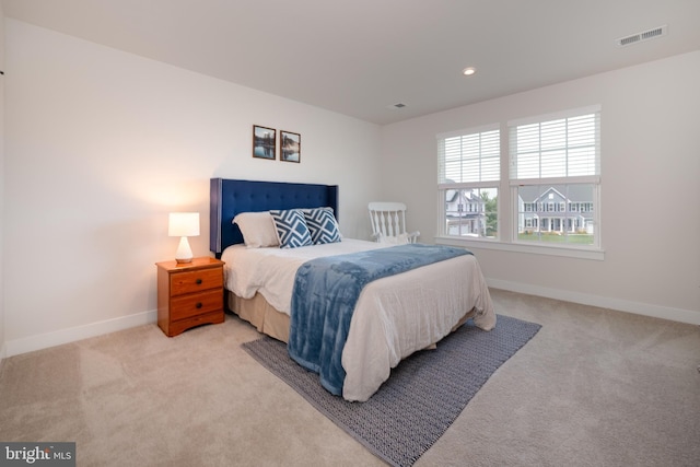 bedroom featuring baseboards, visible vents, recessed lighting, and light colored carpet