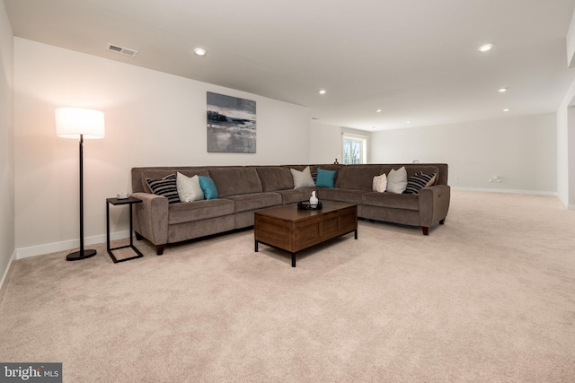 living area with baseboards, visible vents, recessed lighting, and light colored carpet