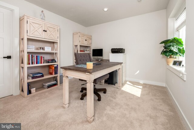 office with light colored carpet and baseboards