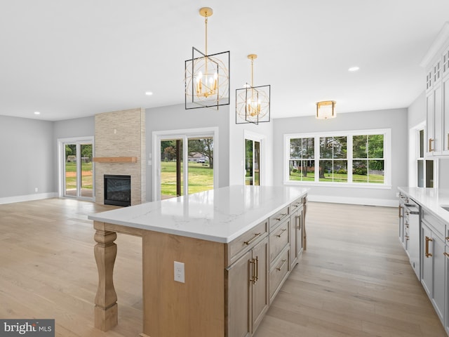 kitchen featuring light wood-style flooring, a center island, recessed lighting, and plenty of natural light