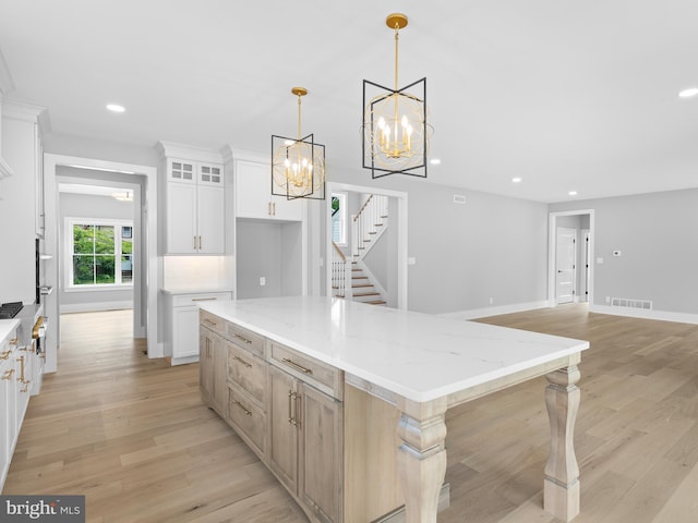 kitchen with light wood-style flooring, an inviting chandelier, and recessed lighting