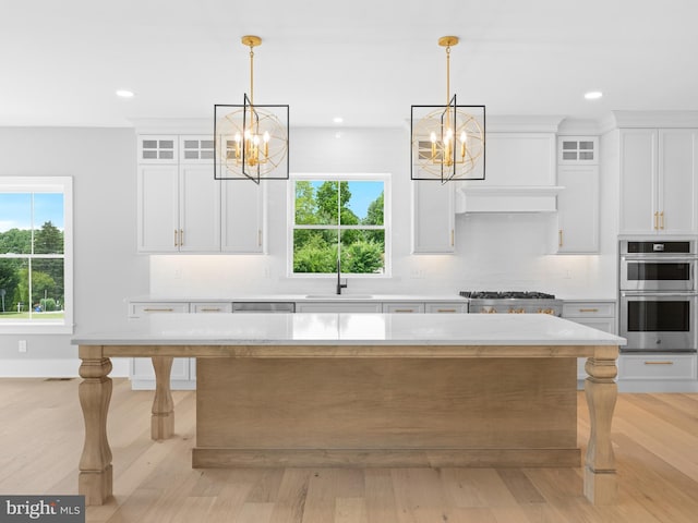 kitchen featuring a chandelier, a healthy amount of sunlight, and appliances with stainless steel finishes