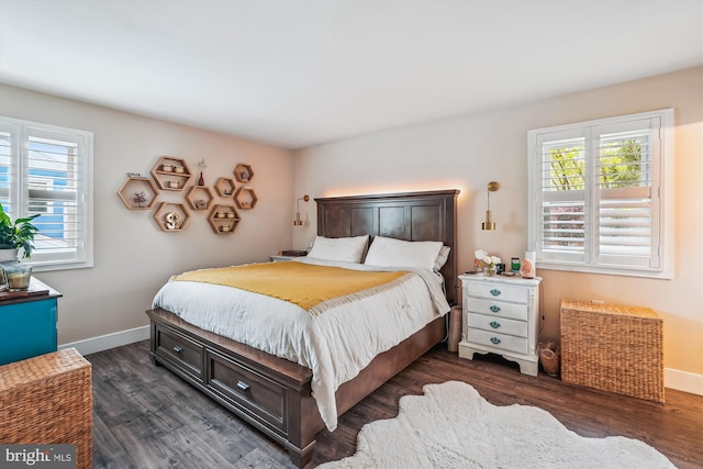 bedroom with dark wood-style flooring, baseboards, and multiple windows
