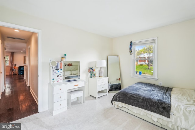 bedroom with baseboards and wood finished floors