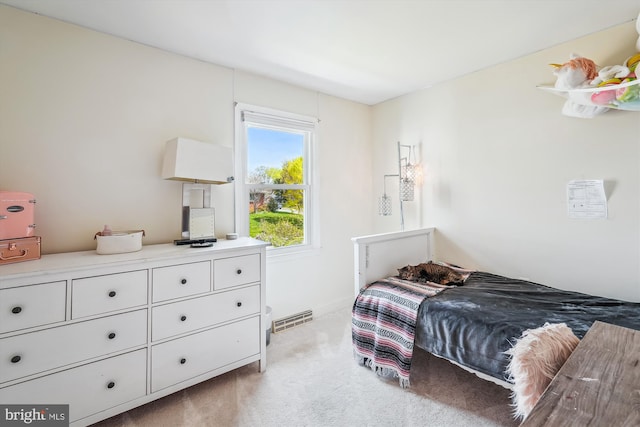 bedroom featuring visible vents, baseboards, and carpet
