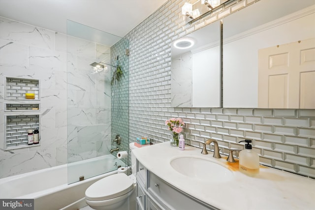 bathroom with tasteful backsplash, vanity, toilet, shower / bathing tub combination, and tile walls