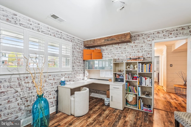 office space with wallpapered walls, ornamental molding, built in study area, visible vents, and wood finished floors