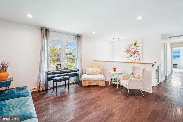 living area with visible vents, dark wood finished floors, and plenty of natural light