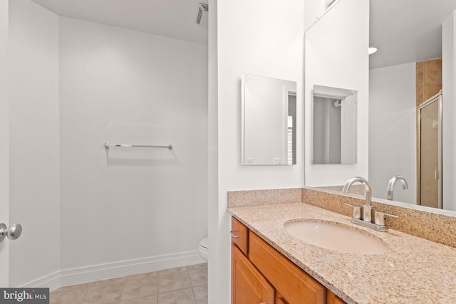 bathroom with tile patterned floors, toilet, a stall shower, baseboards, and vanity