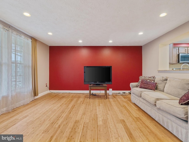 653 Willowby Run, Pasadena, MD 21122 - living room with baseboards, wood finished floors, a textured ceiling, and recessed lighting