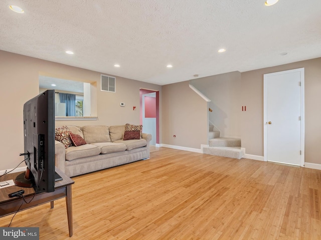 653 Willowby Run, Pasadena, MD 21122 - living room with stairs, a textured ceiling, light wood-style floors, visible vents, and recessed lighting