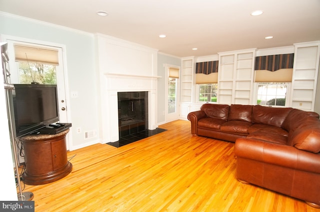 7 Briarwood Dr, Princeton Junction, NJ 08550 - living area with built in shelves, ornamental molding, wood finished floors, and a tiled fireplace