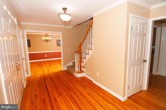 7 Briarwood Dr, Princeton Junction, NJ 08550 - foyer entrance featuring baseboards, light wood finished floors, a notable chandelier, ornamental molding, and stairs