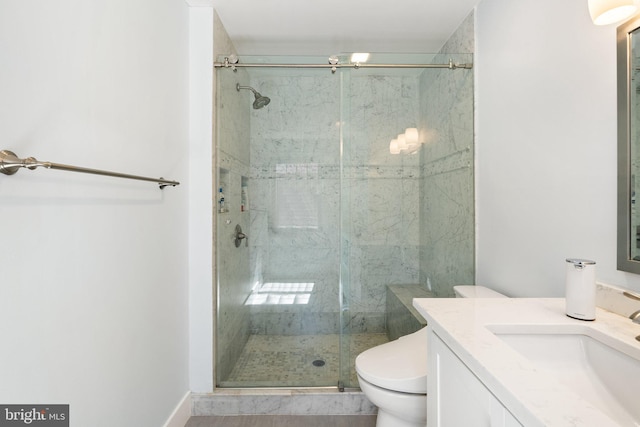full bath with vanity, toilet, and a shower stall