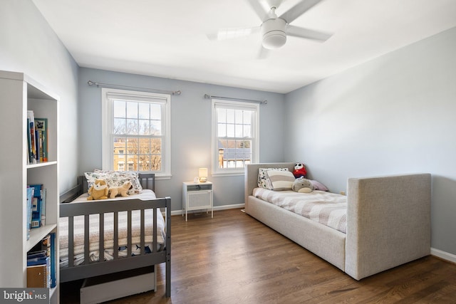 bedroom with a ceiling fan, baseboards, and wood finished floors
