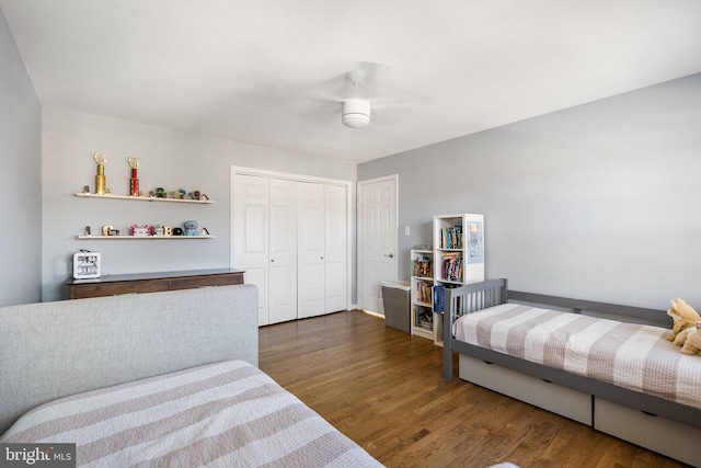 bedroom with a closet, a ceiling fan, and wood finished floors