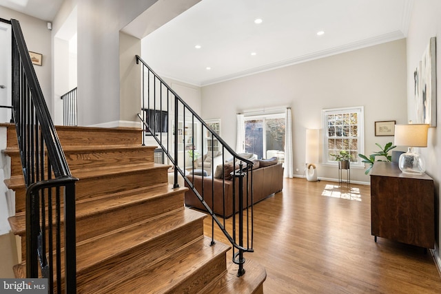 stairway with crown molding, baseboards, recessed lighting, and wood finished floors