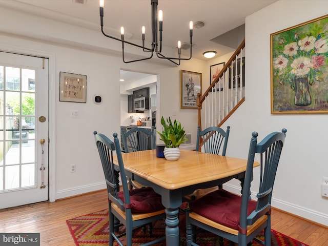 15 Morris St, Annapolis, MD 21401 - dining room with a chandelier, light wood-style floors, baseboards, and stairs