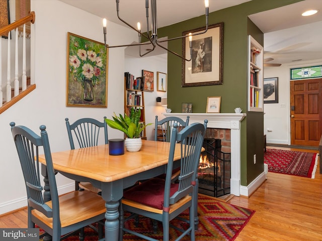 15 Morris St, Annapolis, MD 21401 - dining area with wood finished floors, a chandelier, baseboards, stairway, and a fireplace