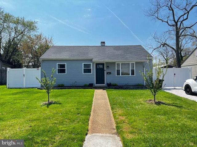 view of front of property with a gate, fence, and a front yard