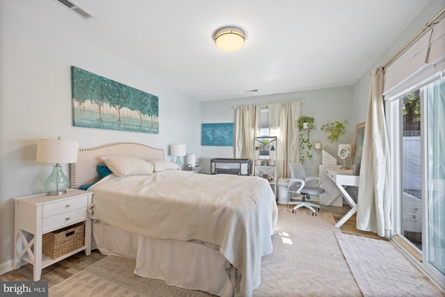 bedroom with visible vents and wood finished floors