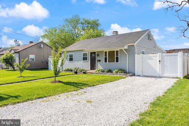 ranch-style house featuring a front lawn, fence, gravel driveway, a chimney, and a gate