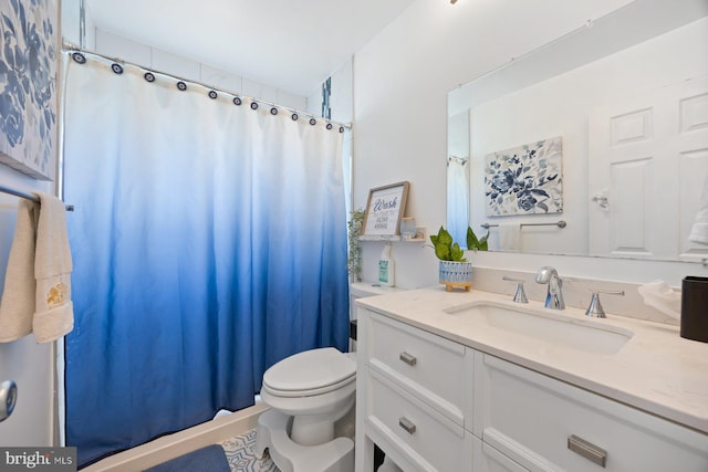 bathroom featuring vanity, toilet, and curtained shower