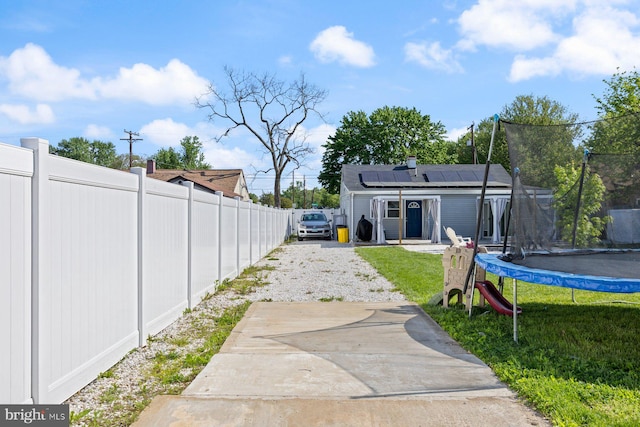 exterior space with a trampoline and fence private yard