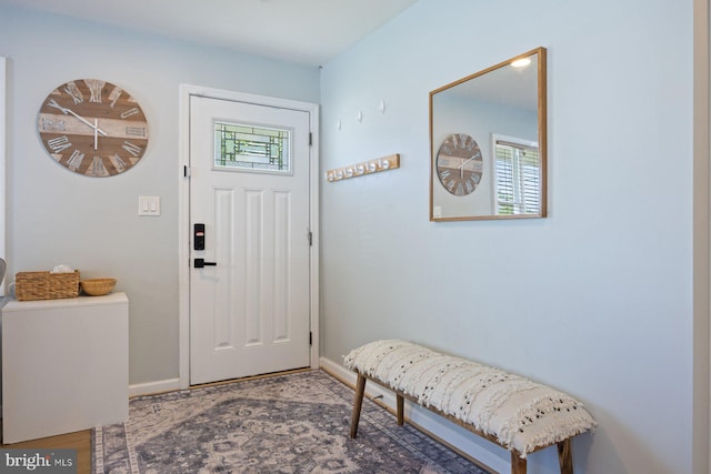 foyer featuring baseboards