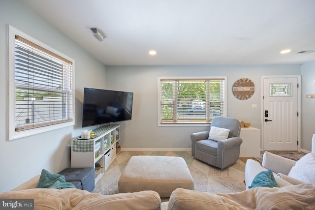 living area with visible vents, recessed lighting, and baseboards