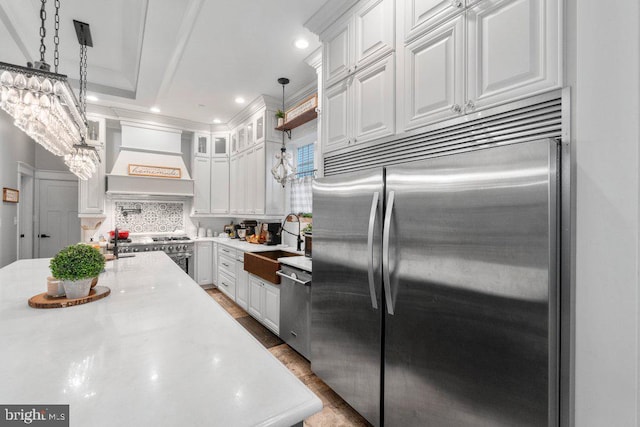 9136 Cowenton Ave, Perry Hall, MD 21128 - kitchen with high end appliances, premium range hood, a sink, white cabinets, and recessed lighting